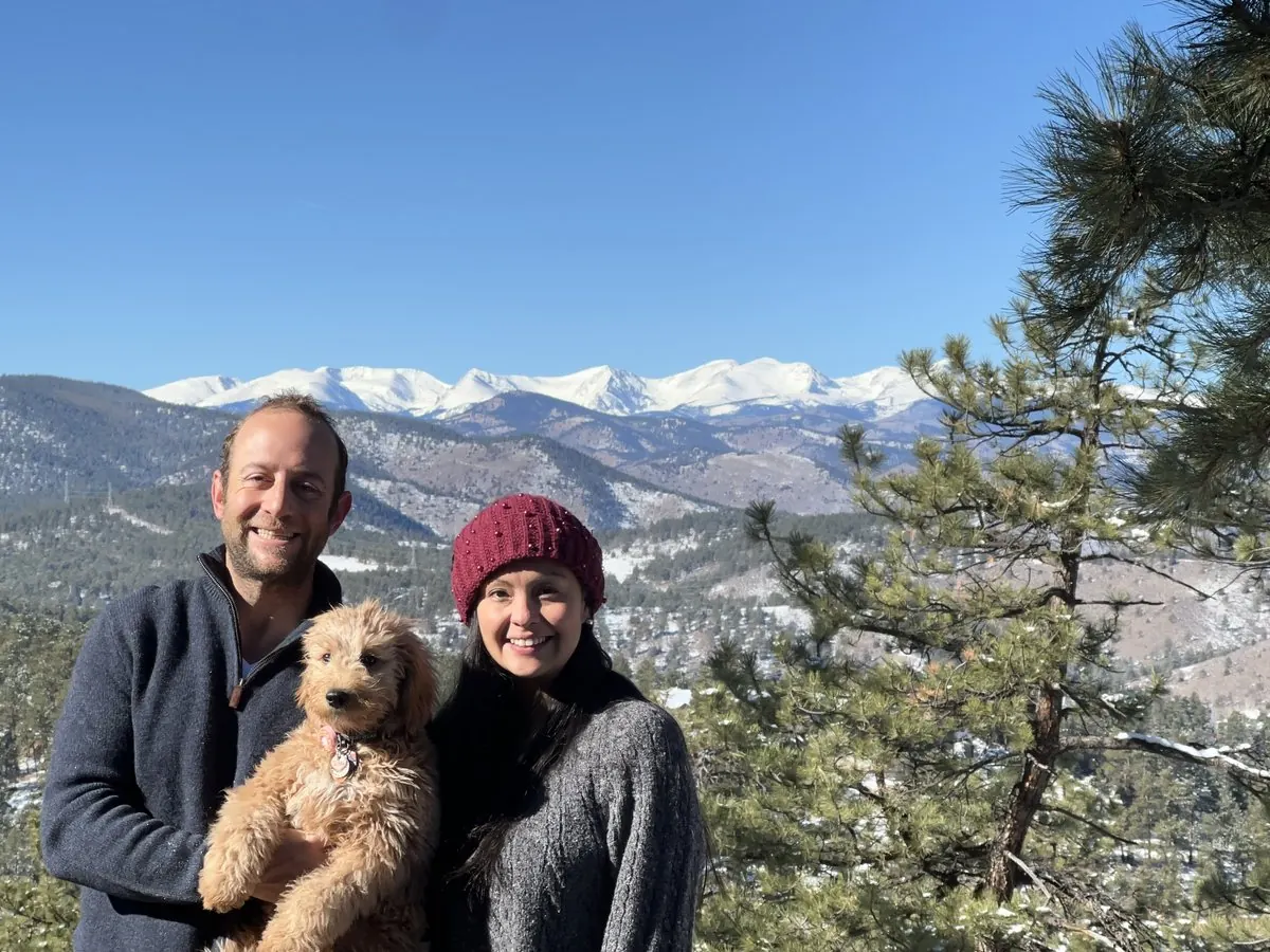 Mily and Danny Dodson with their dog, the Continental Divide behind them